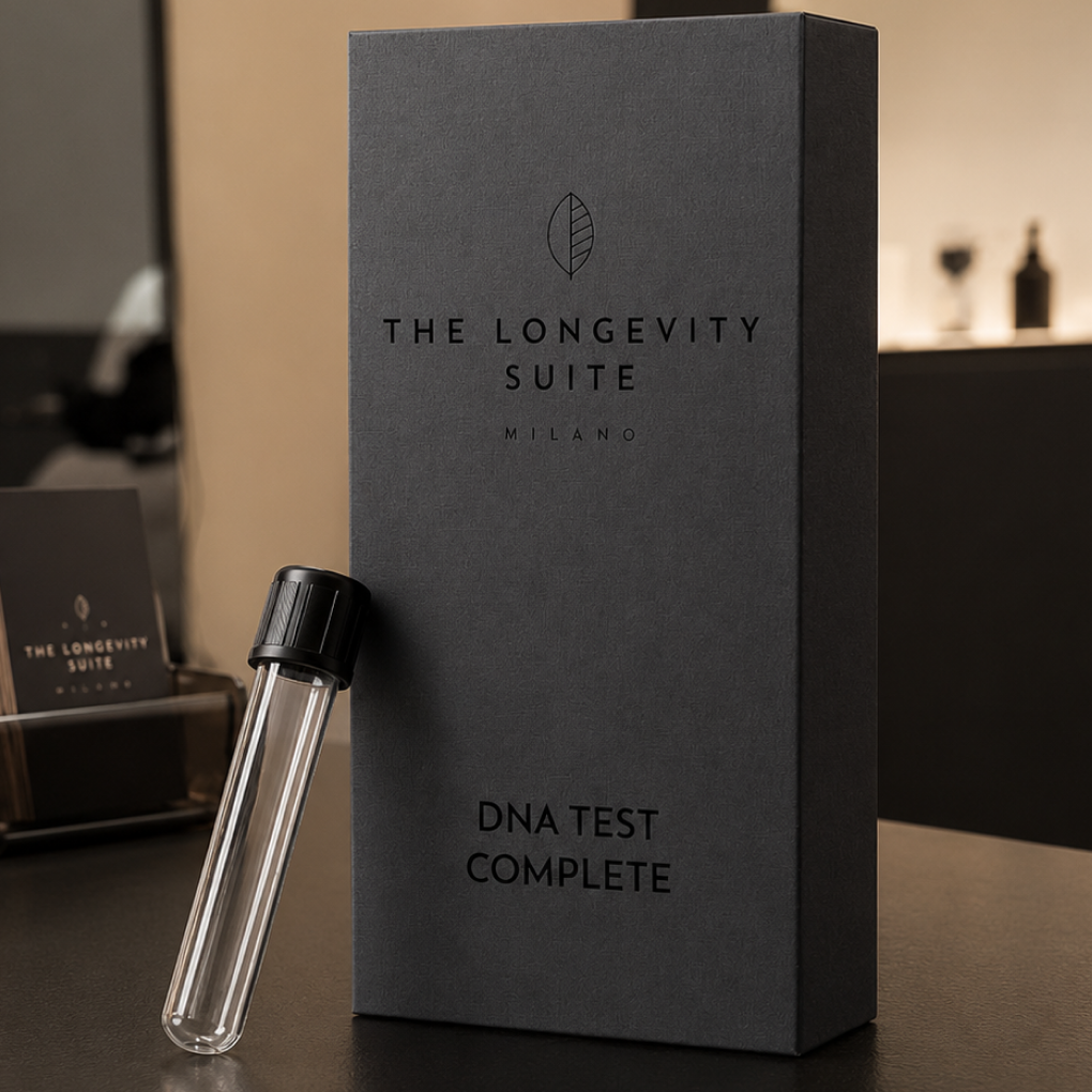 Dark grey product box labeled 'The Longevity Suite Milano DNA Test Complete' next to a clear collection tube with a black cap.