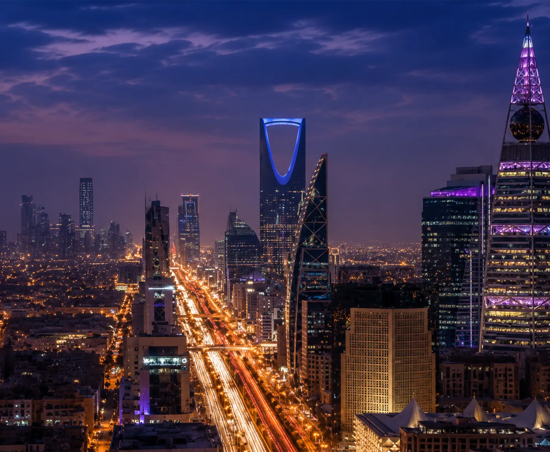 Illuminated city skyline of Riyadh, Saudi Arabia at night.
